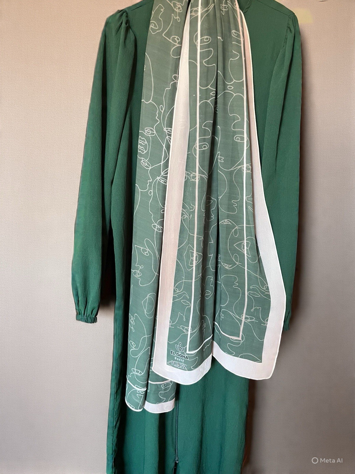 Dark green color abaya with matching hijab.
