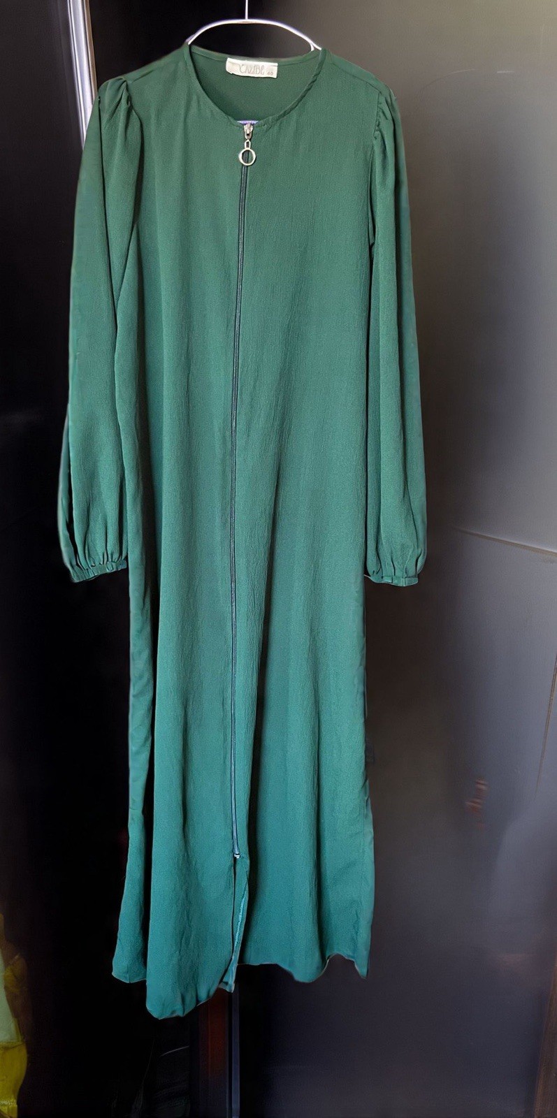 Dark green color abaya with matching hijab.