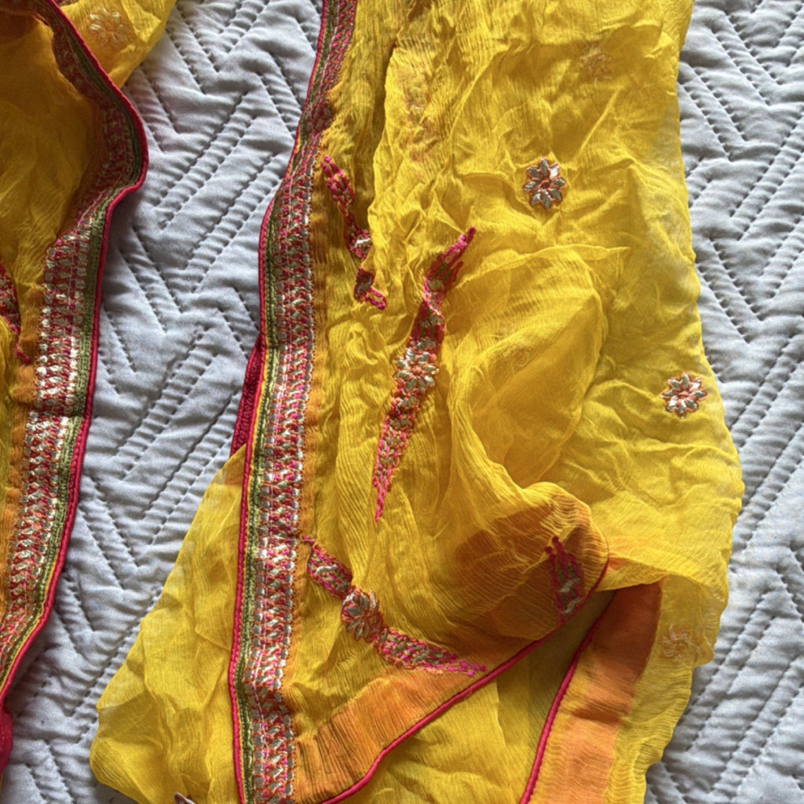 Yellow Chiffon Saree with Pink, Orange, and Gold Embroidered Border